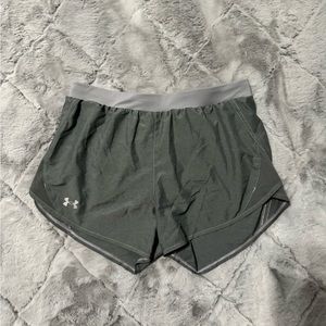 They are grey, size medium and the material is dry fit